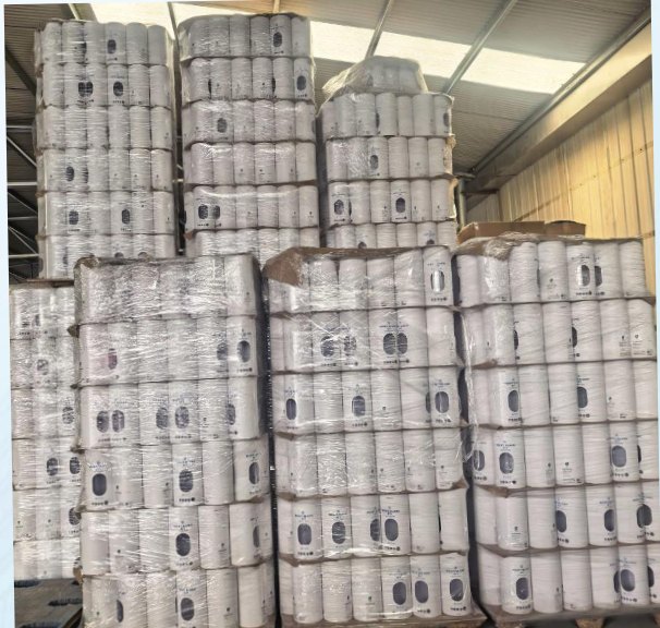 Wrapped finished textile rolls stacked in the factory store